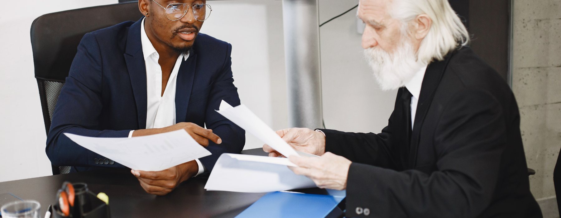 Two advisors comparing figures across a set of papers