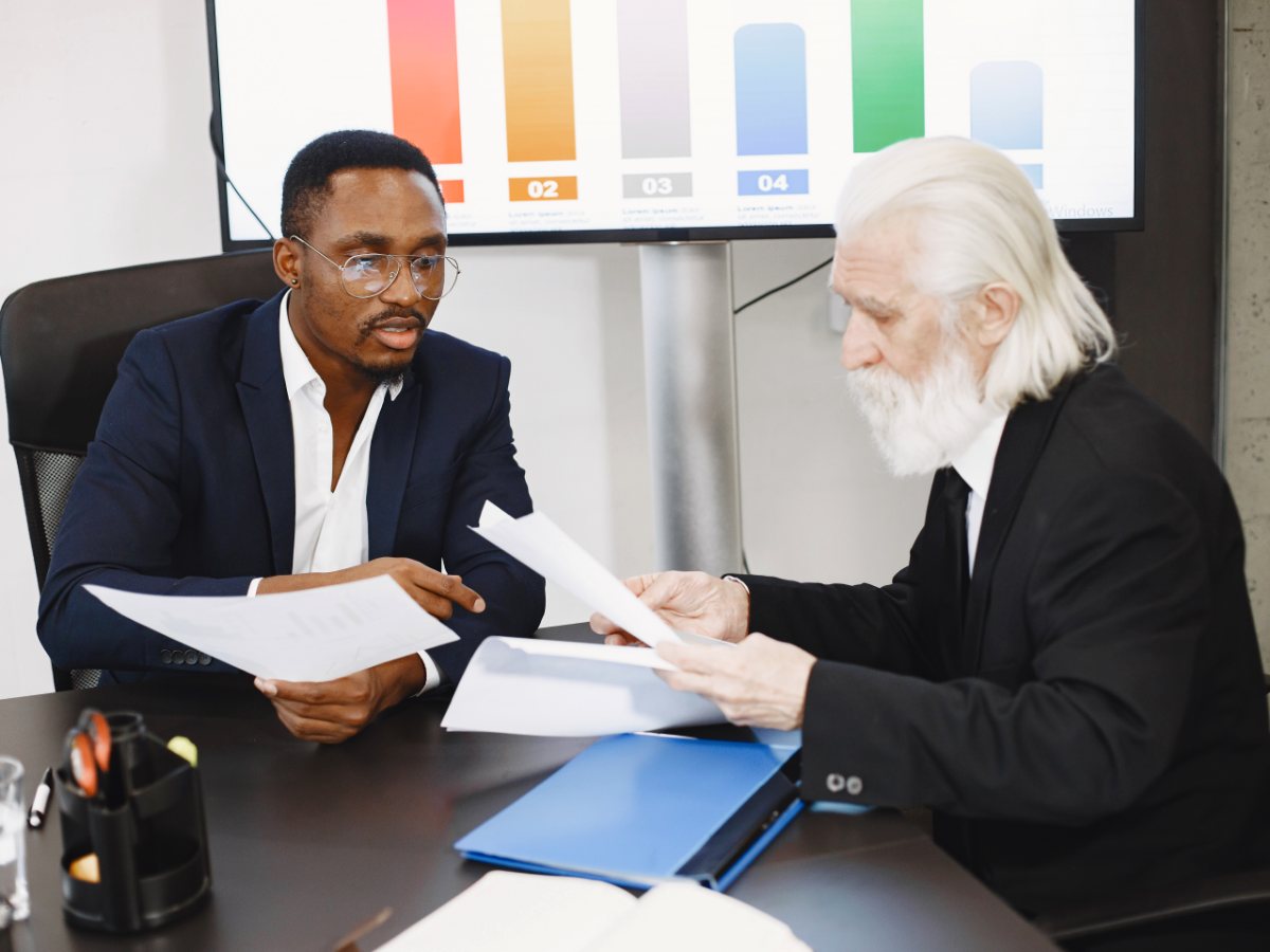 Two advisors comparing figures across a set of papers