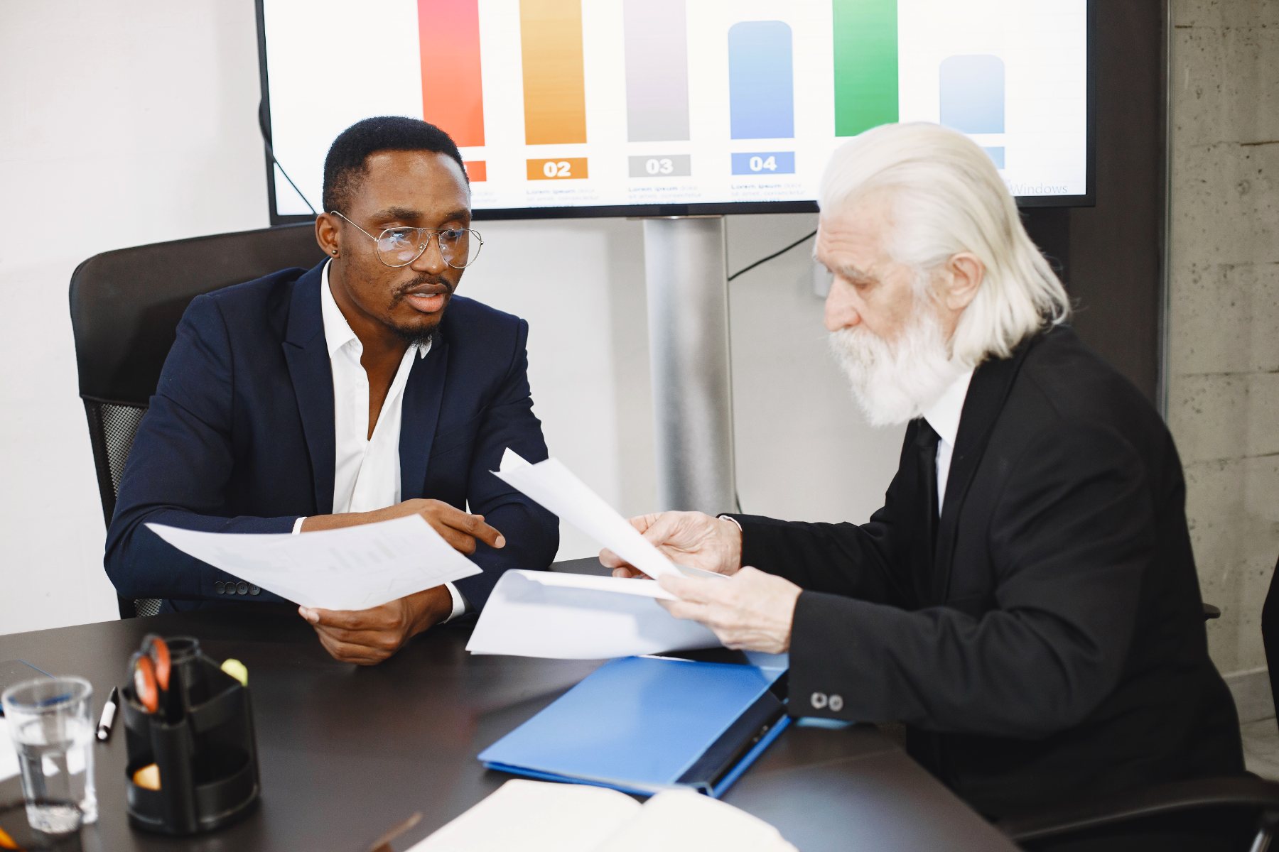 Two advisors comparing figures across a set of papers